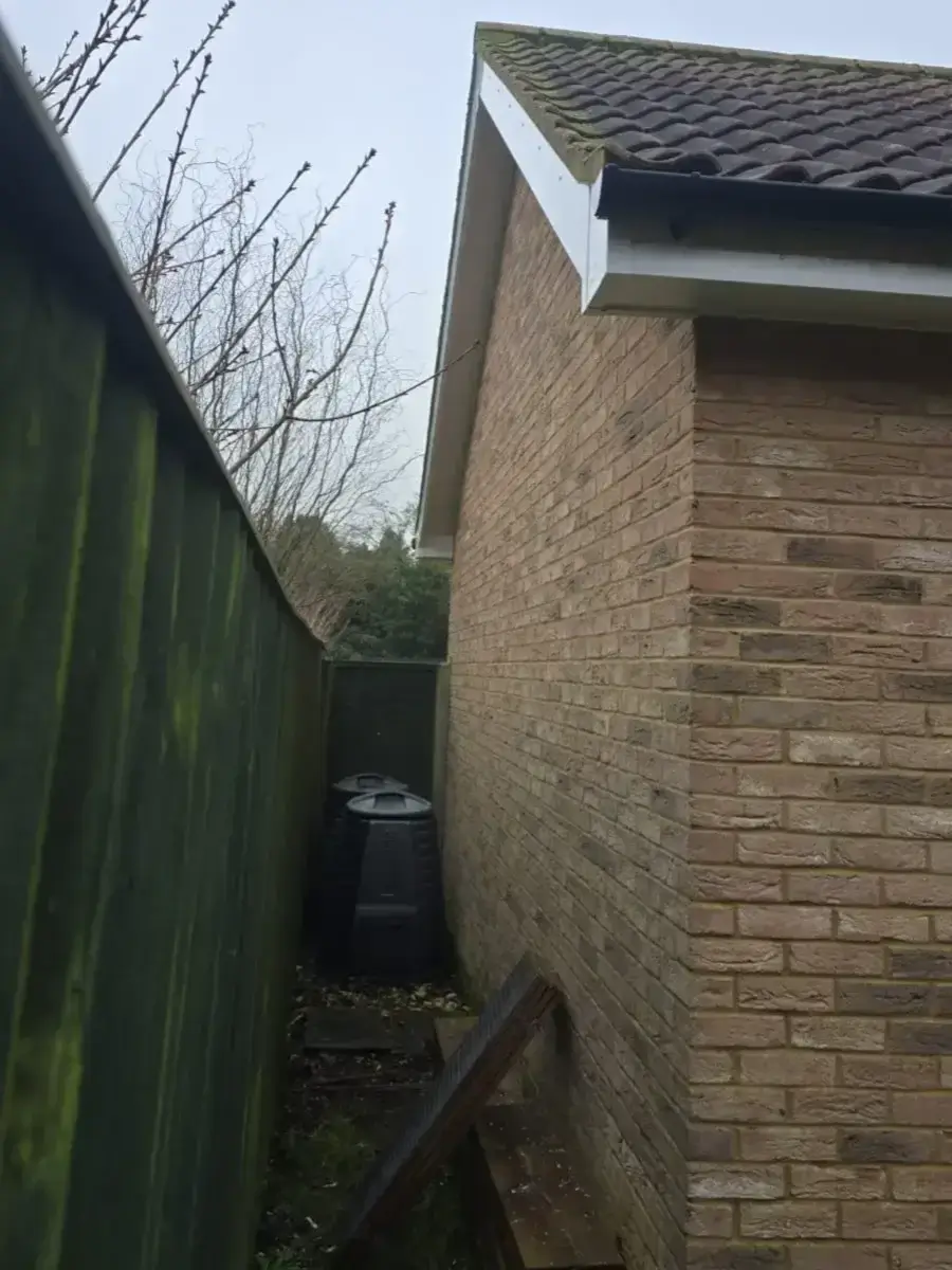 Clean lines of newly fitted white uPVC fascia boards and ventilated soffits on a residential gable end. Installed by Norfolk Exterior Solutions